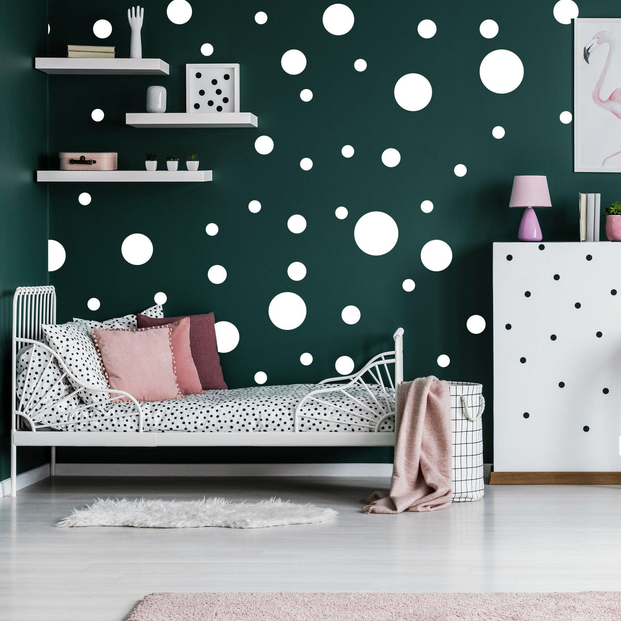 Cozy bedroom featuring a green wall decorated with white round dot stickers and a stylish bed with polka-dot bedding.
