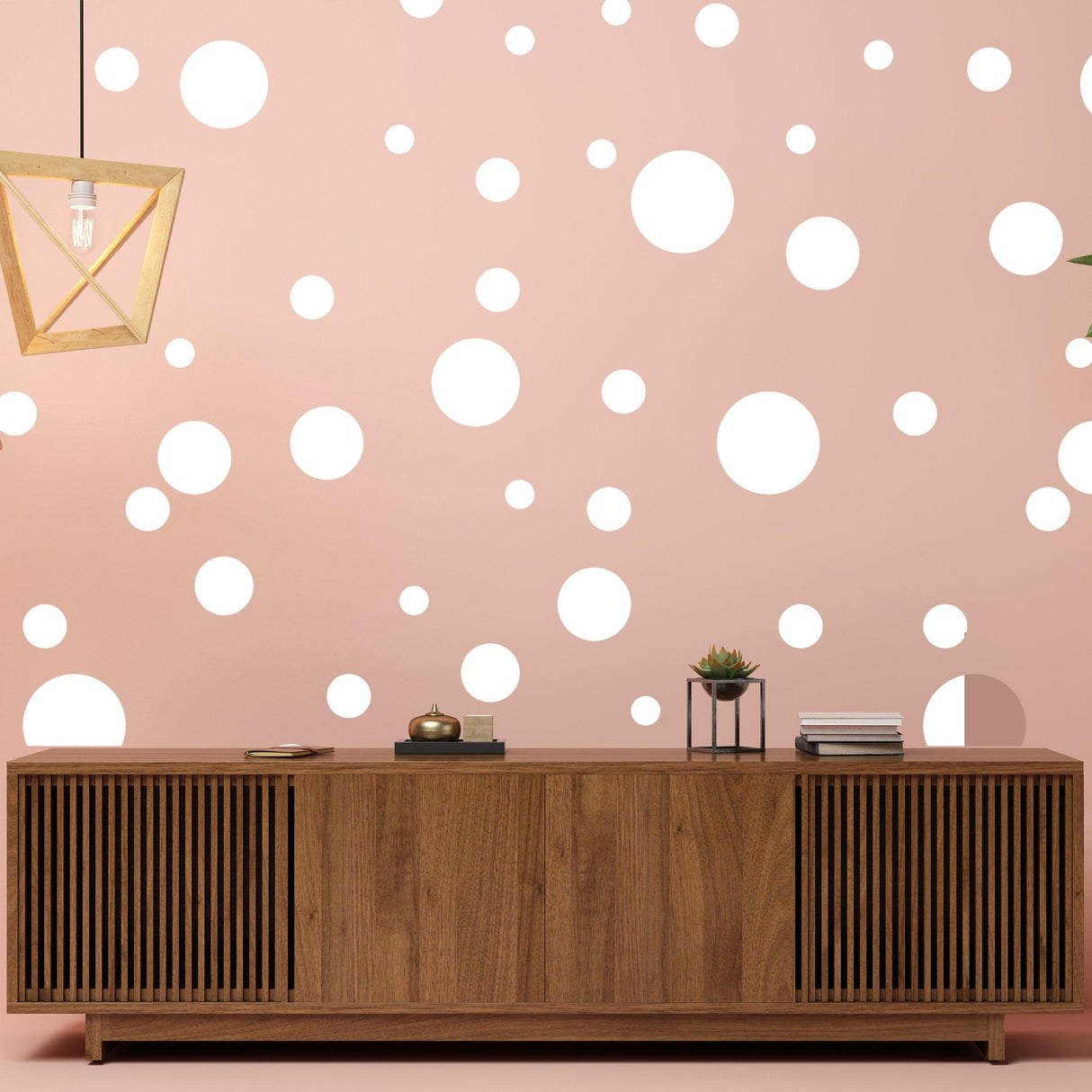 Wooden cabinet in front of pink wall with white round dot stickers for decor.