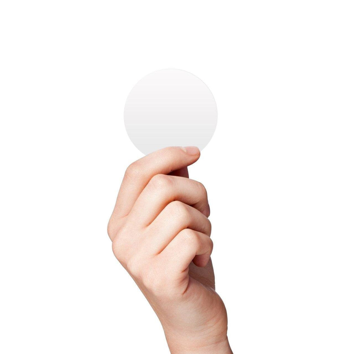 Hand holding a 2-inch blank white round circle sticker on a plain background for labeling or organizing.