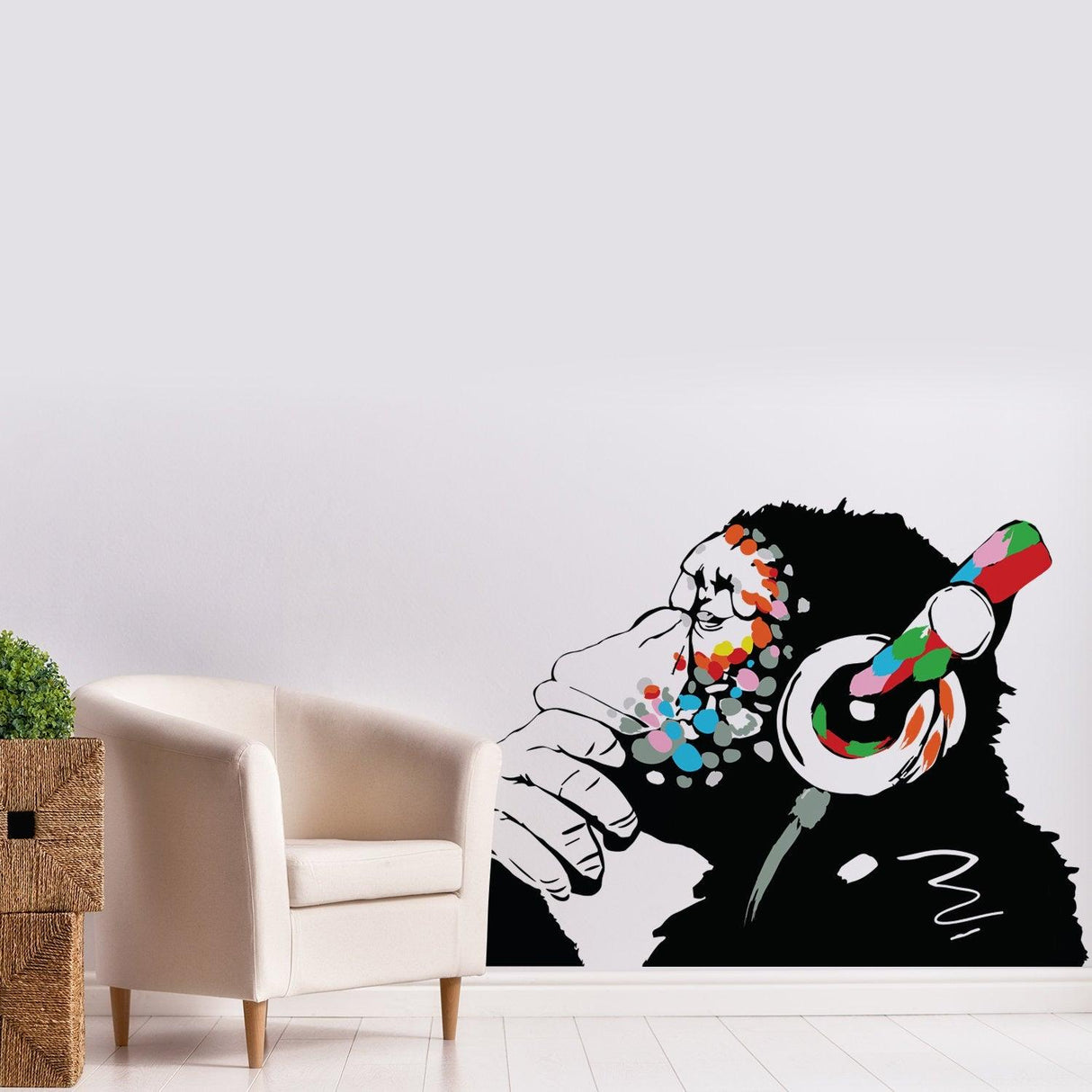 Banksy monkey with headphones wall sticker in modern living room, adding unique art and color to decor.