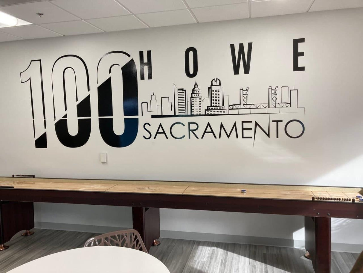 Wall art featuring '100 Howe Sacramento' with a skyline design, enhancing modern office decor.