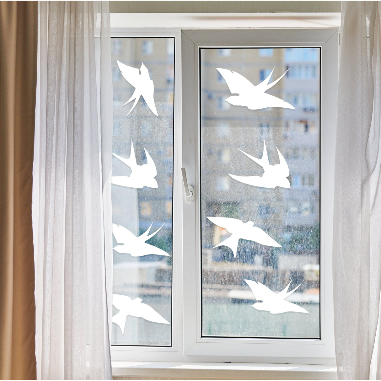 Frosted window decals featuring birds to prevent collisions and protect wildlife.
