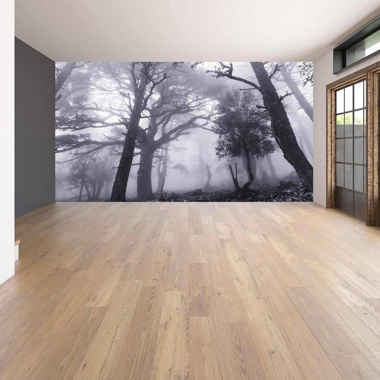 Foggy forest wallpaper mural in a spacious room with wooden flooring and large windows, creating a serene atmosphere.