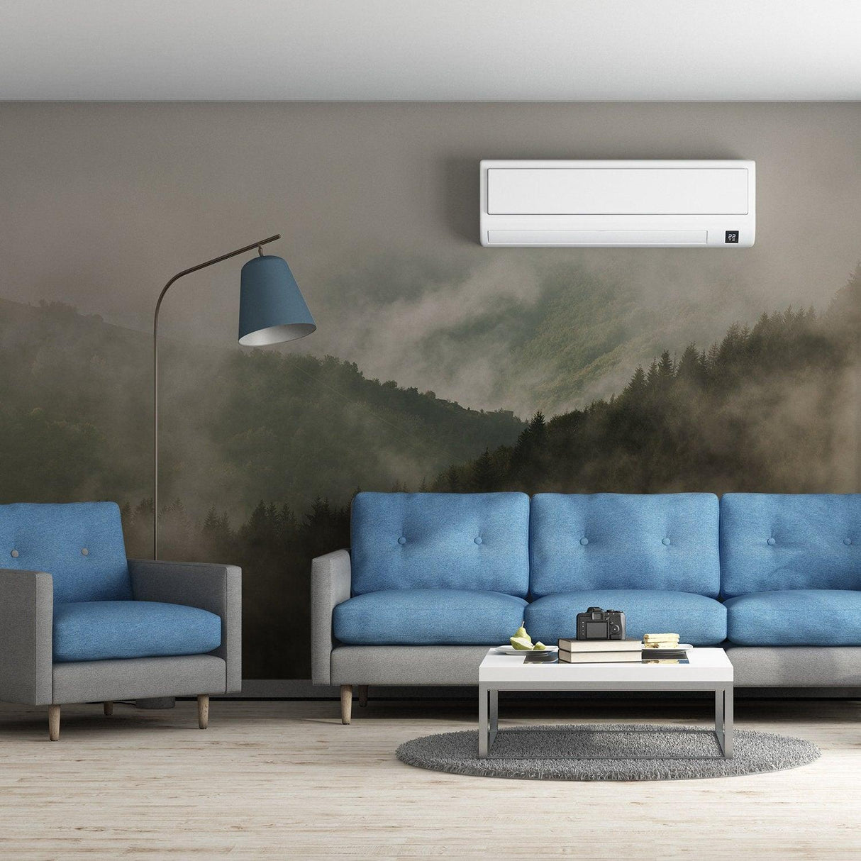 Foggy forest wallpaper mural in a modern living room with blue couches and floor lamp.