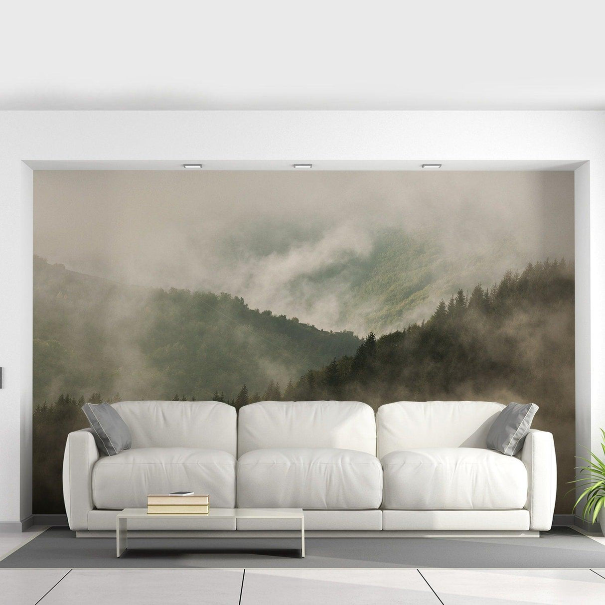 Custom wallpaper decal of misty mountains behind a modern white sofa in a stylish room.