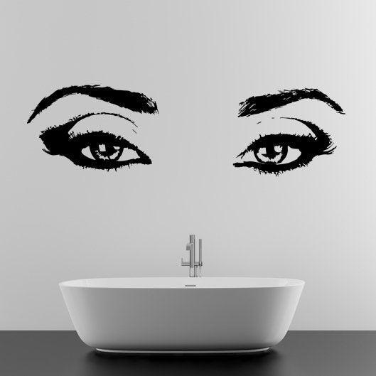 Elegant black vinyl eye wall decal above a modern bathtub, perfect for stylish bathroom decor.