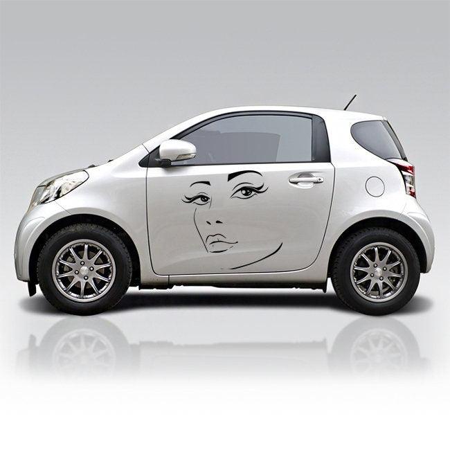 Car with a stylish decal of a woman's face on its side, adding a unique and artistic touch to vehicle decor.