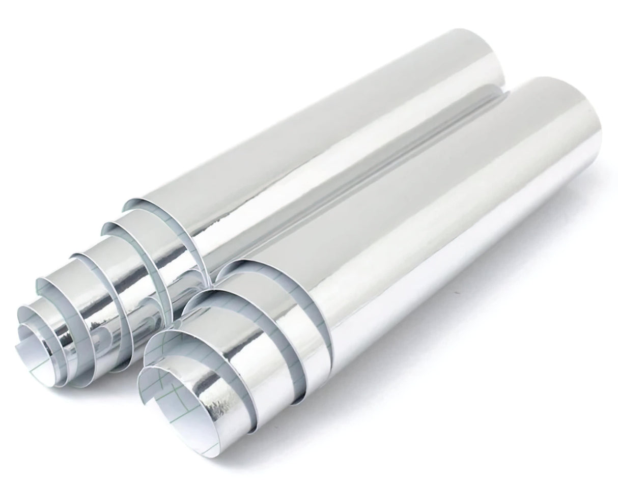 Two rolls of shiny silver chrome vinyl sticker wrap for car interiors, showcasing a sleek metallic finish.