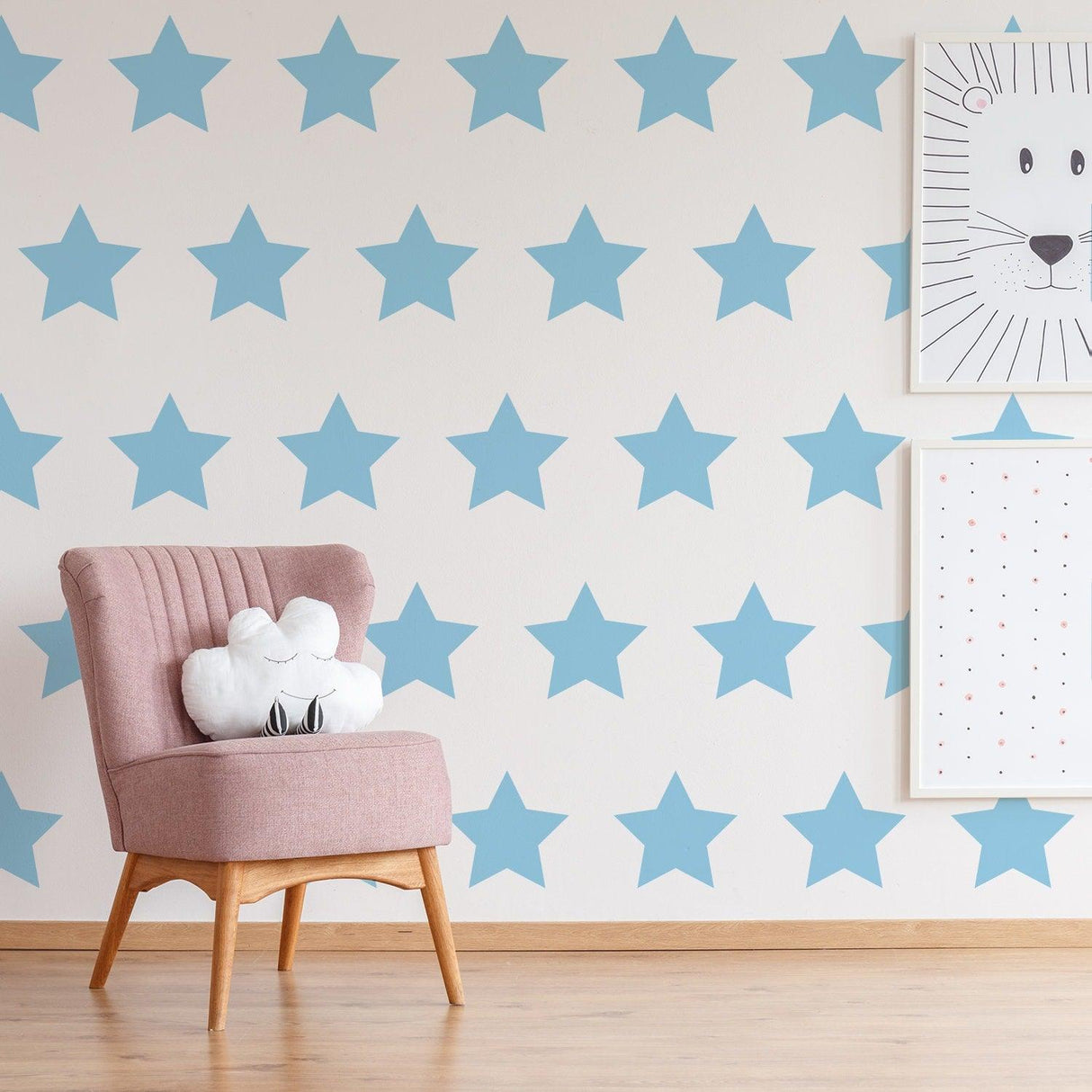 Blue star wall decals in nursery with pink chair and cute decor elements, perfect for children's rooms.