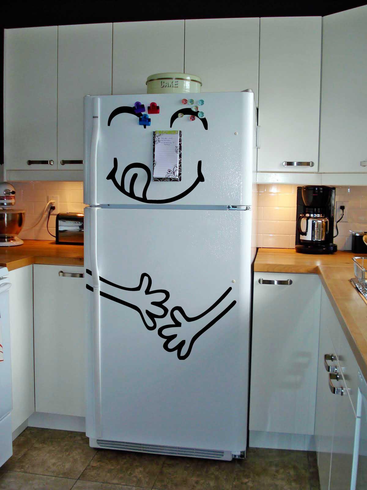 Funny happy face vinyl decal on a white refrigerator, adding humor to kitchen decor with quirky design.