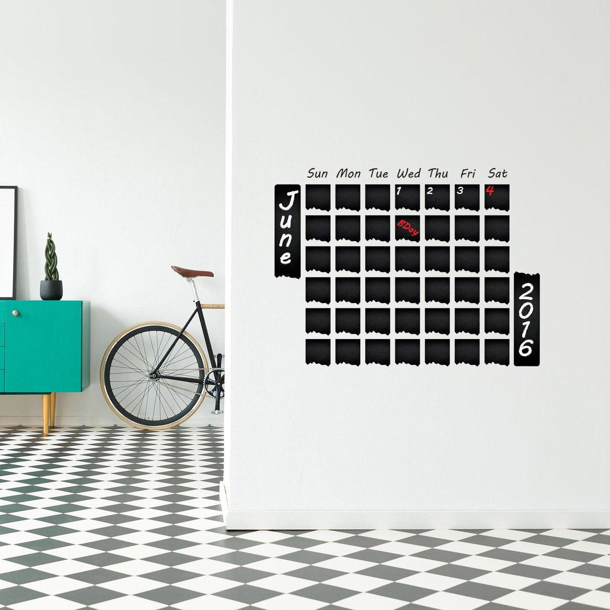 Chalkboard wall planner in modern kitchen, featuring monthly calendar design for organizing tasks and meals.