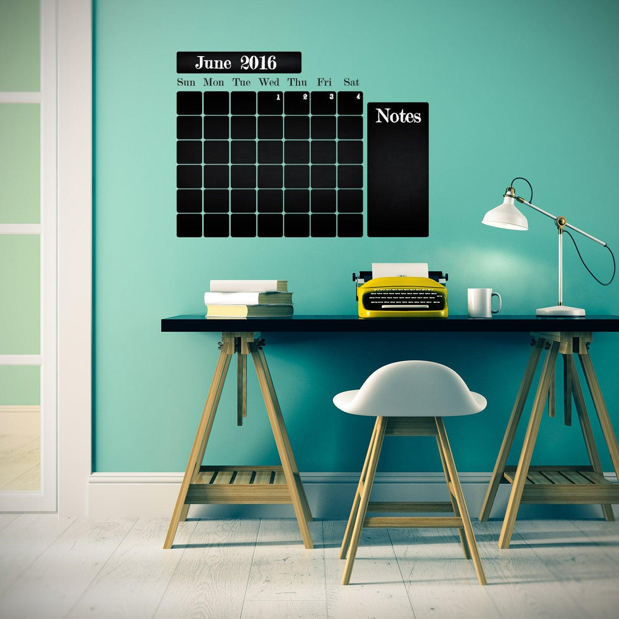 Chalkboard wall planner sticker on a teal wall, featuring a monthly calendar and notes section, enhancing organization.
