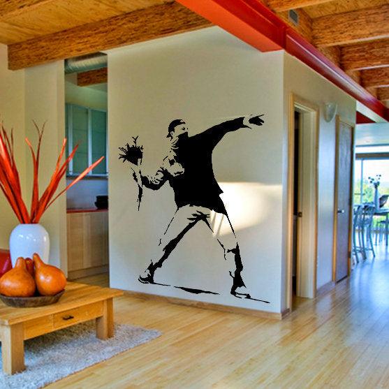 Banksy Flower Thrower wall decal in a stylish living room, showcasing urban art and street decor.