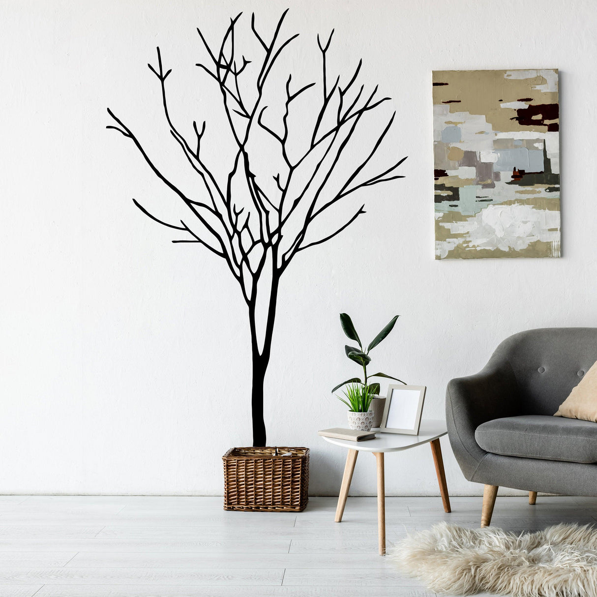 Black birch tree wall decal in a modern living room with a stylish couch and decor.