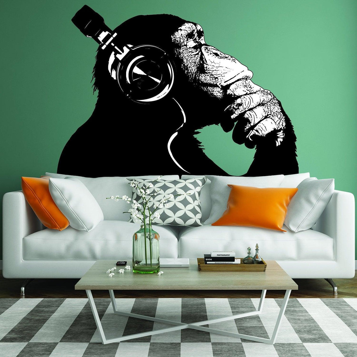 Banksy monkey wall sticker with headphones on a green wall above a modern sofa and coffee table in a stylish living room.