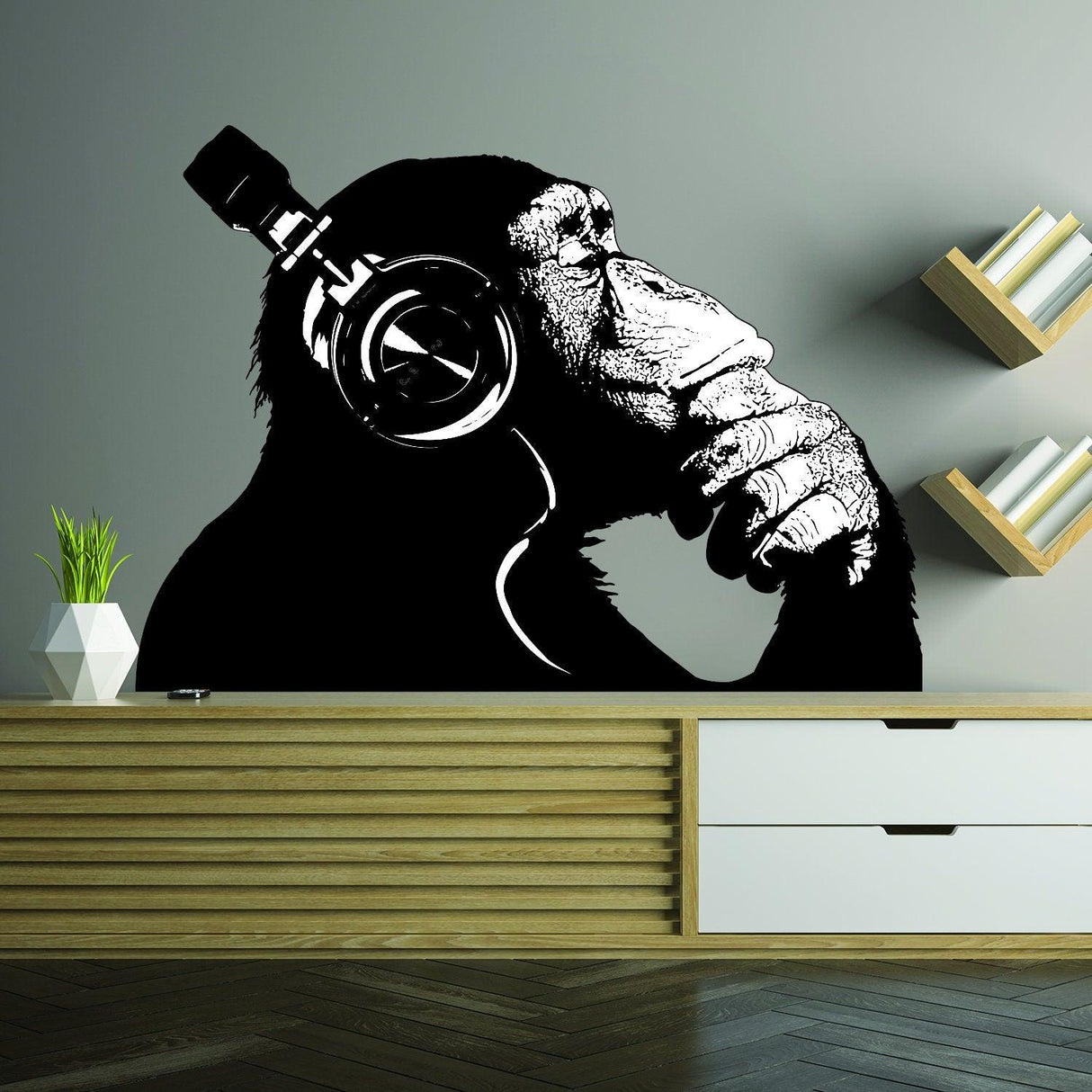 Playful monkey wearing headphones, enjoying music, featured as a unique wall decal for home decor.