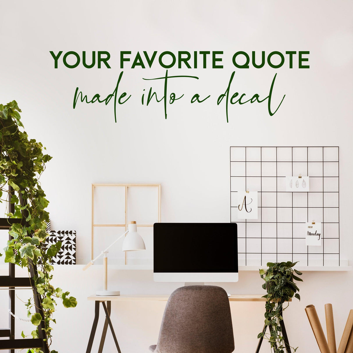 Custom quote decal on wall in stylish workspace with greenery and modern desk setup.