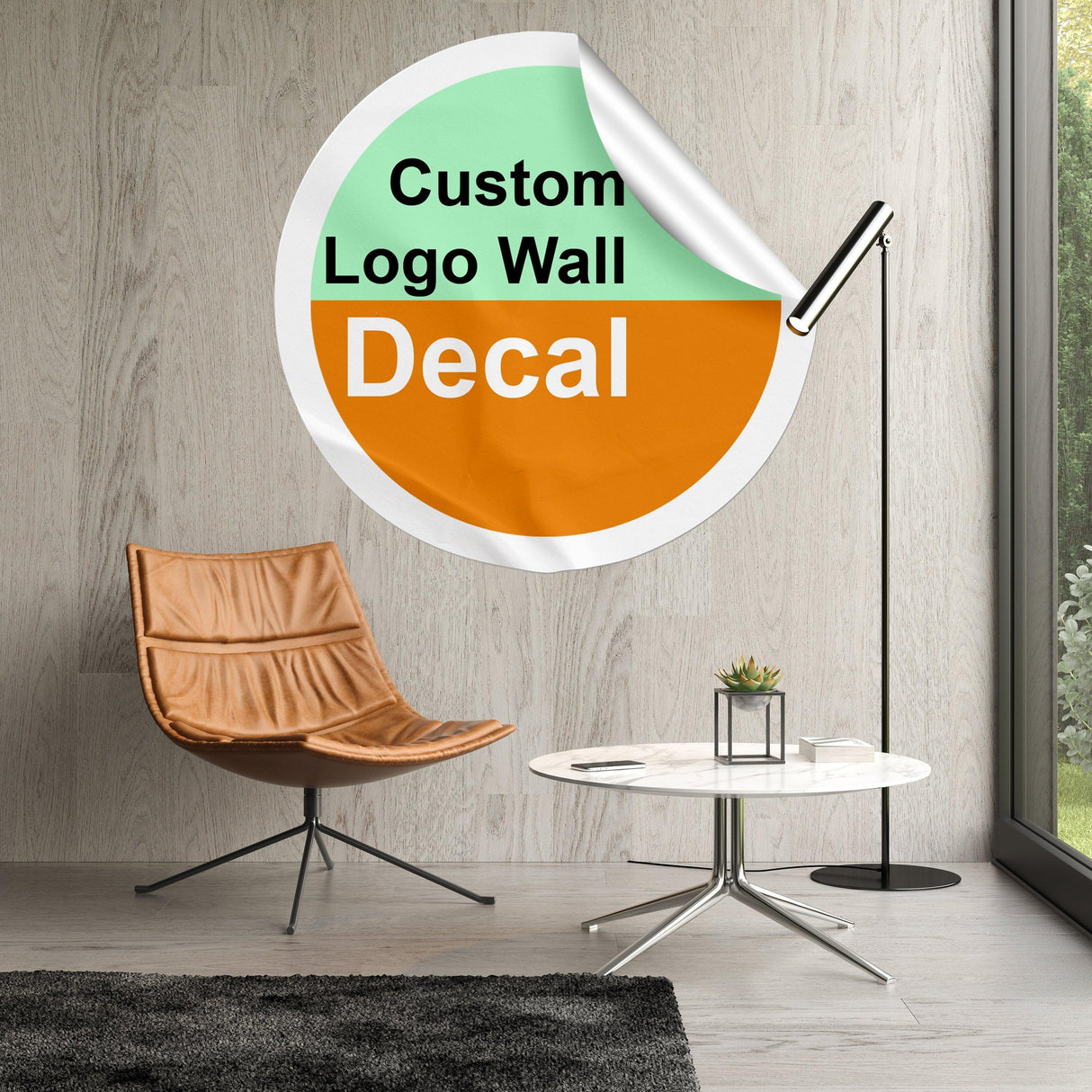 Custom logo wall decal displayed in a modern living room with chair and table.