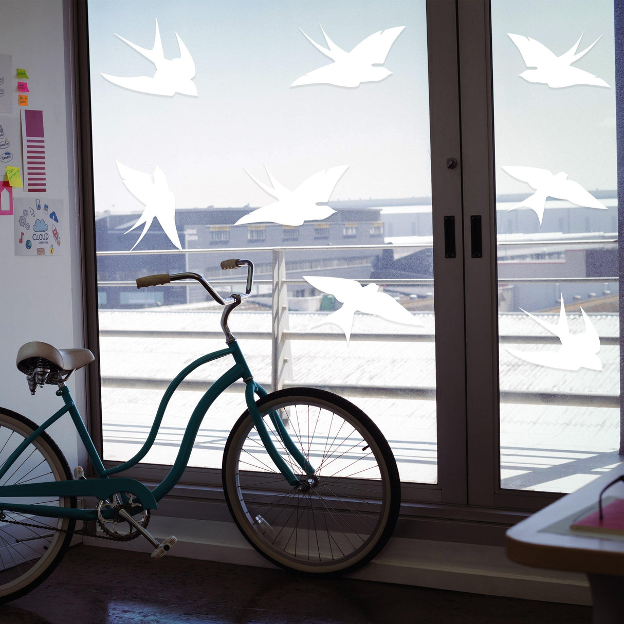 Bird decals on glass windows to prevent bird collisions, showcasing elegant design in a stylish indoor setting.