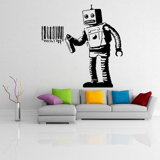 Banksy barcode robot wall sticker applied above a modern sofa in a stylish living room, showcasing urban street art.