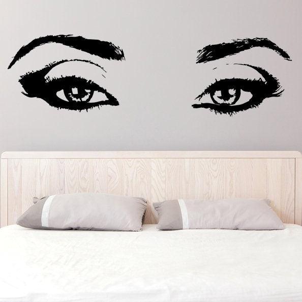Beautiful female eye wall decal above a bed, perfect for bedroom decor.
