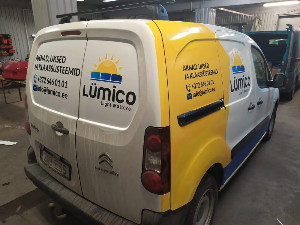 Custom van wrap showcasing Lumico branding and contact details in an industrial garage.