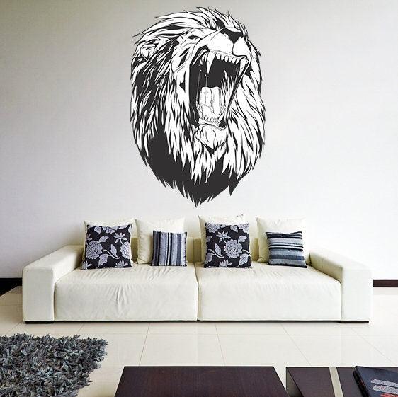 Lion head wall decal on a living room wall above a white sofa with decorative pillows.