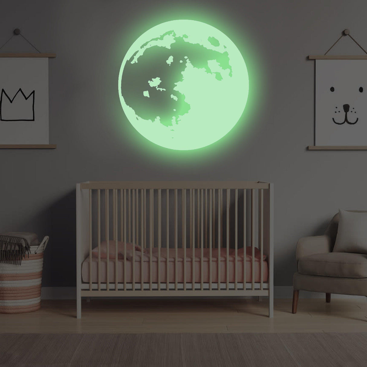 Glow in the dark moon wall sticker illuminating a child's bedroom with crib and decorative wall art.