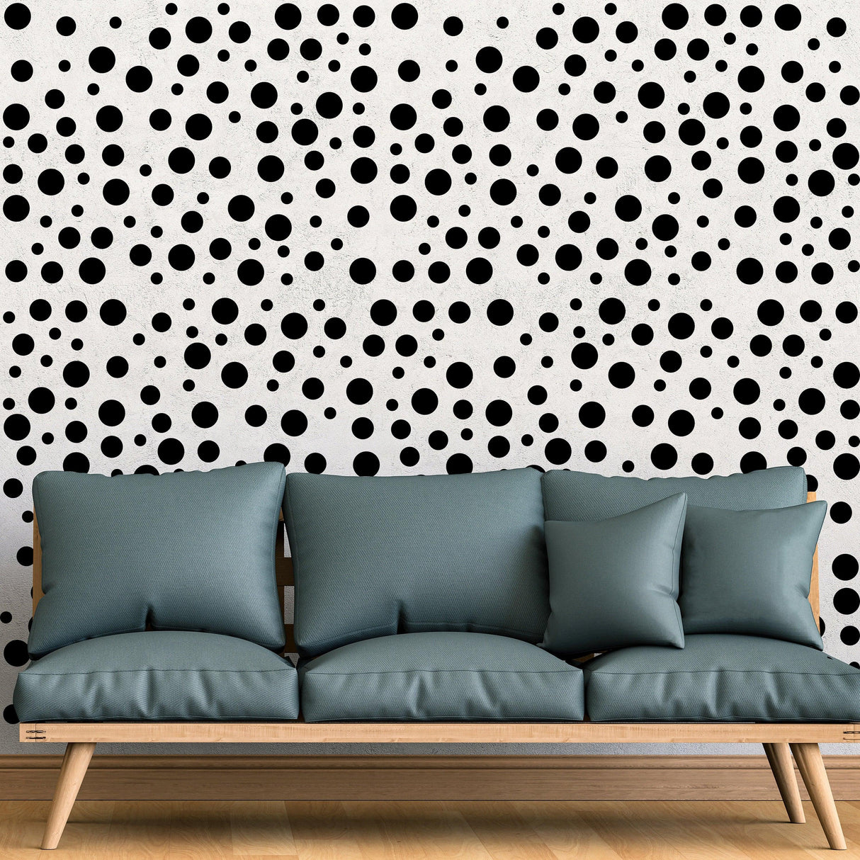 Polka dots wall decals in black on white background behind a stylish couch in a comfortable room setting.