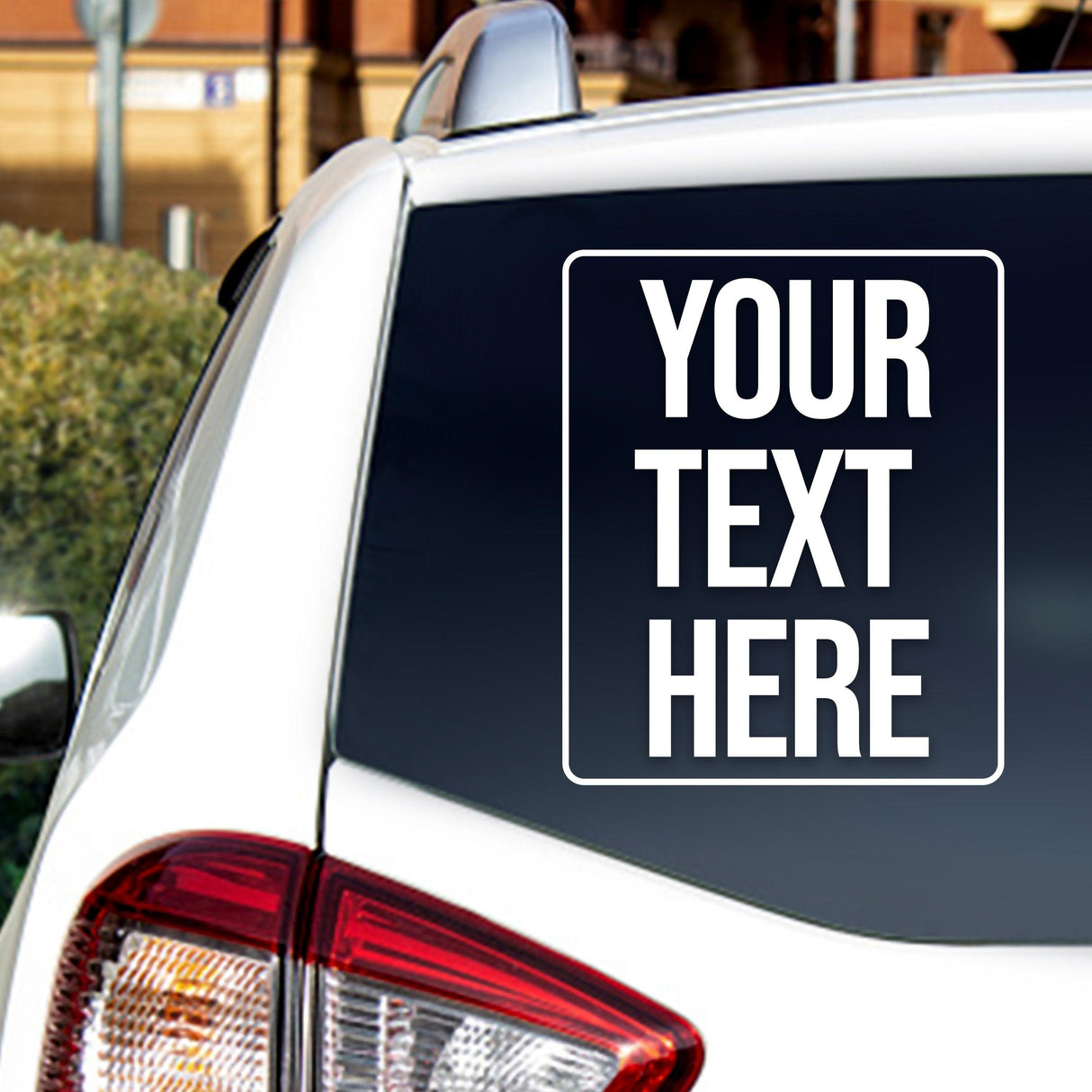 Custom car window decal featuring personalized text on a white vehicle's rear windshield.