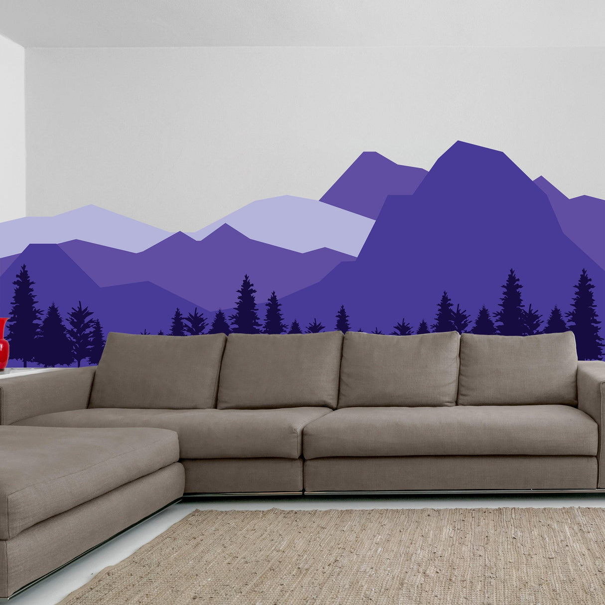 Mountain wall decal in purple hues above a modern sectional sofa, creating a serene nursery decor.