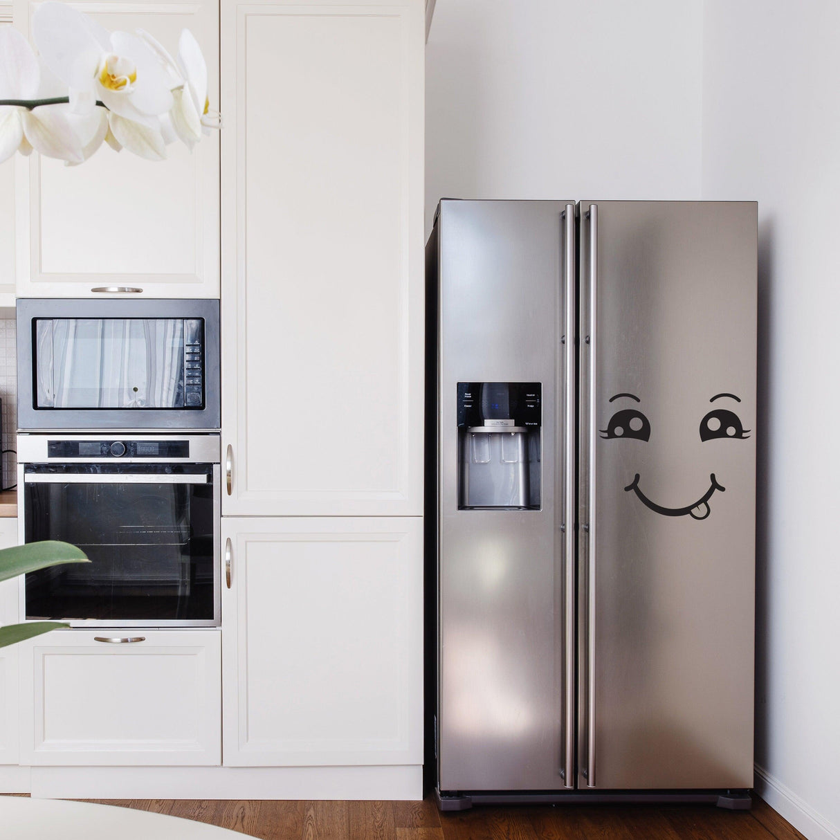 Happy face vinyl decal on a stainless steel refrigerator in a modern kitchen, adding personality and charm.