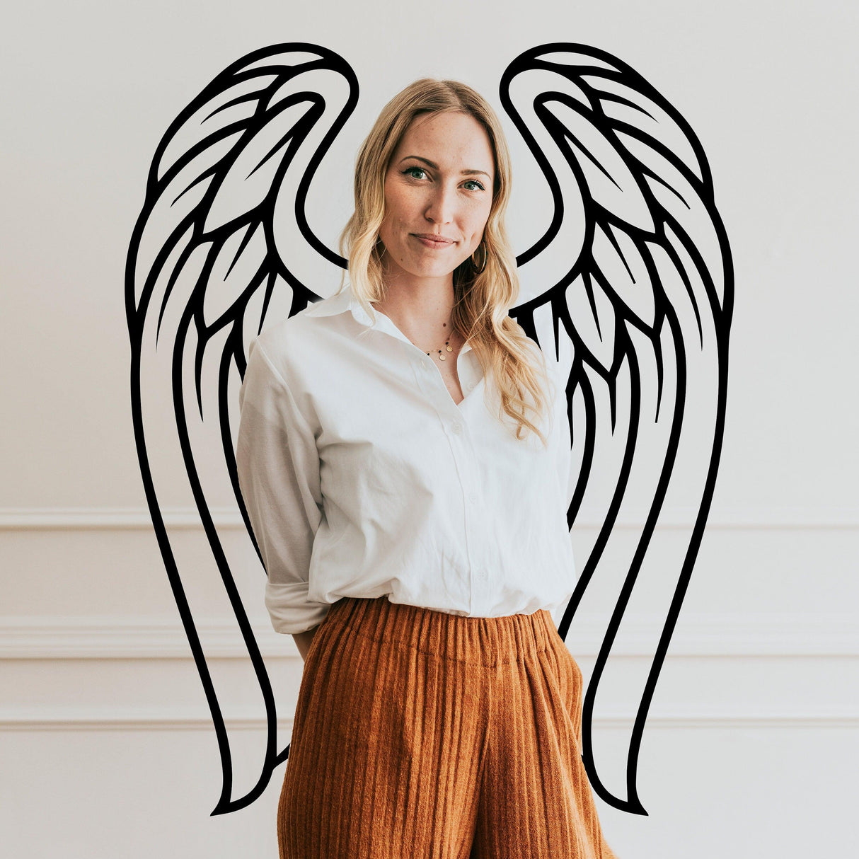 Woman wearing a white shirt with angel wings vinyl decal in the background, symbolizing elegance and beauty.