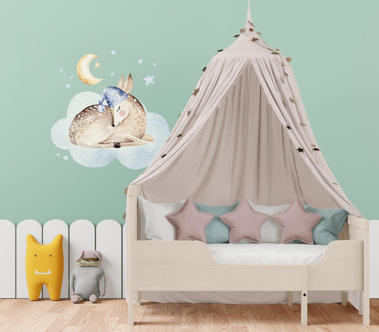 Baby nursery wall decor featuring animal cloud dream decal and cozy bed with stars and playful accents.