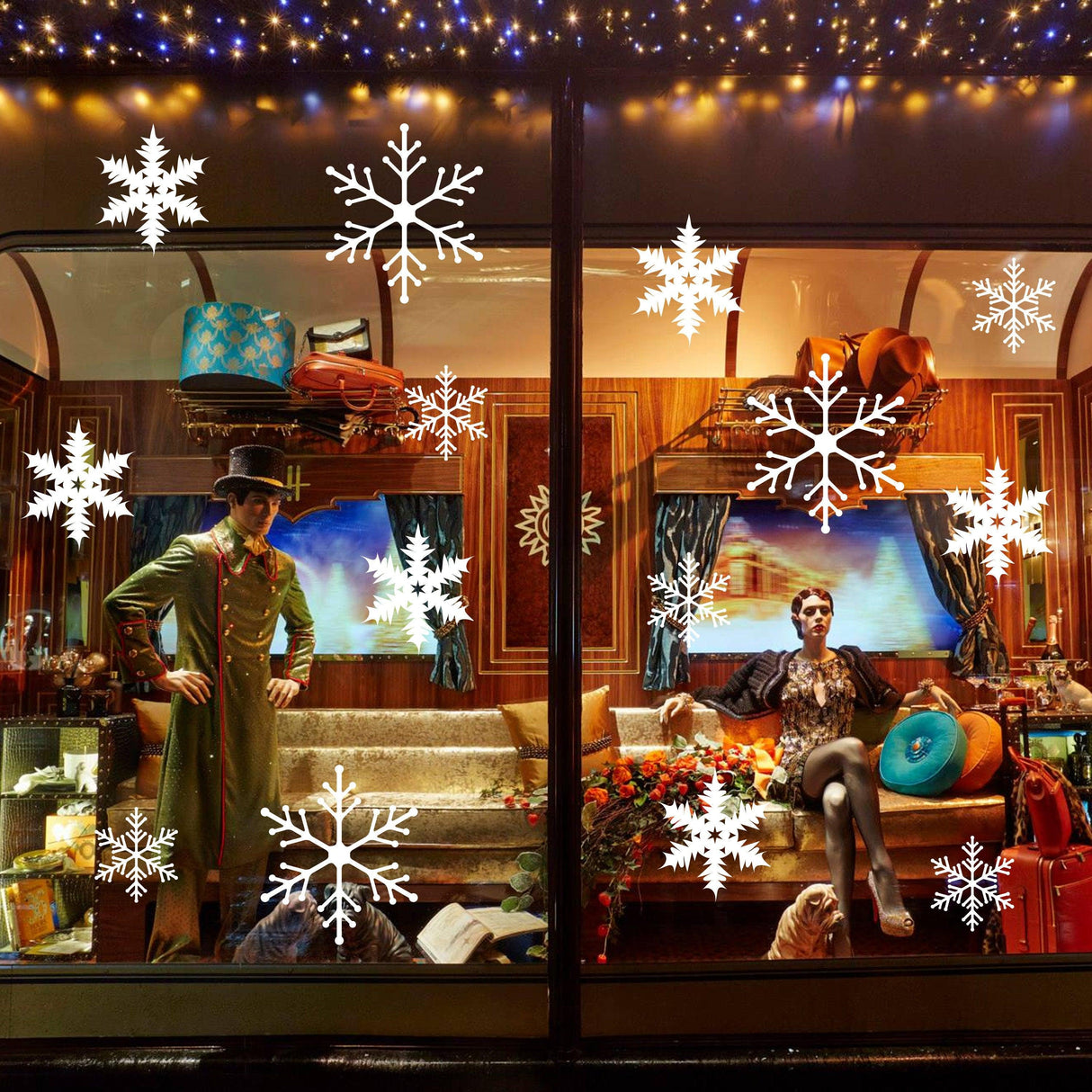 Decorative window display featuring snowflake stickers, showcasing festive Christmas spirit with holiday decorations.