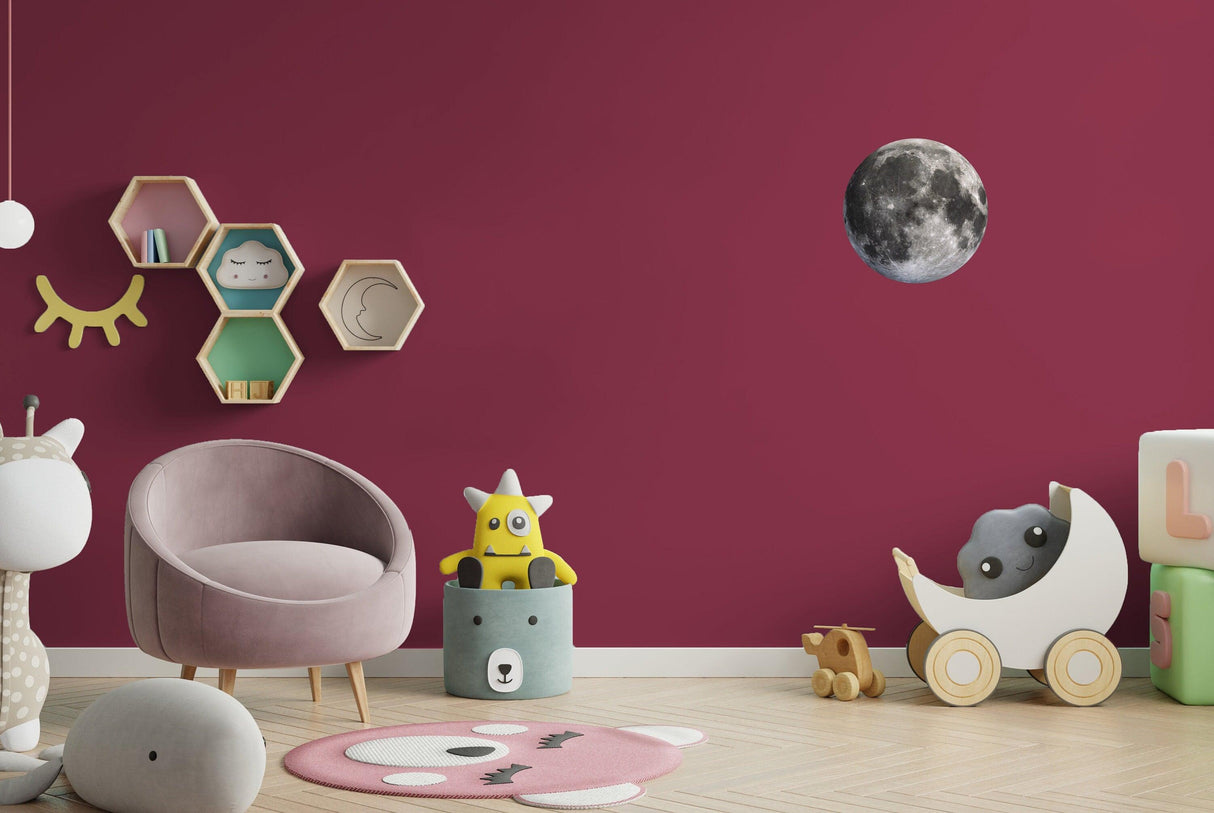 Full Moon Wall Sticker on a deep pink wall with children's toys and furniture, adding a whimsical touch to the room.