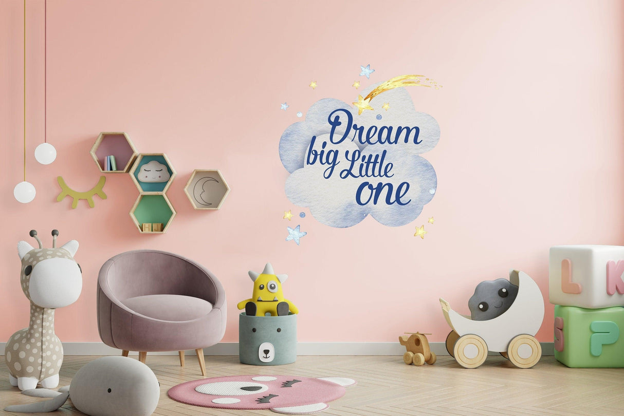 Colorful nursery wall sticker featuring clouds and 'Dream big Little one' text in a playful baby room setting.