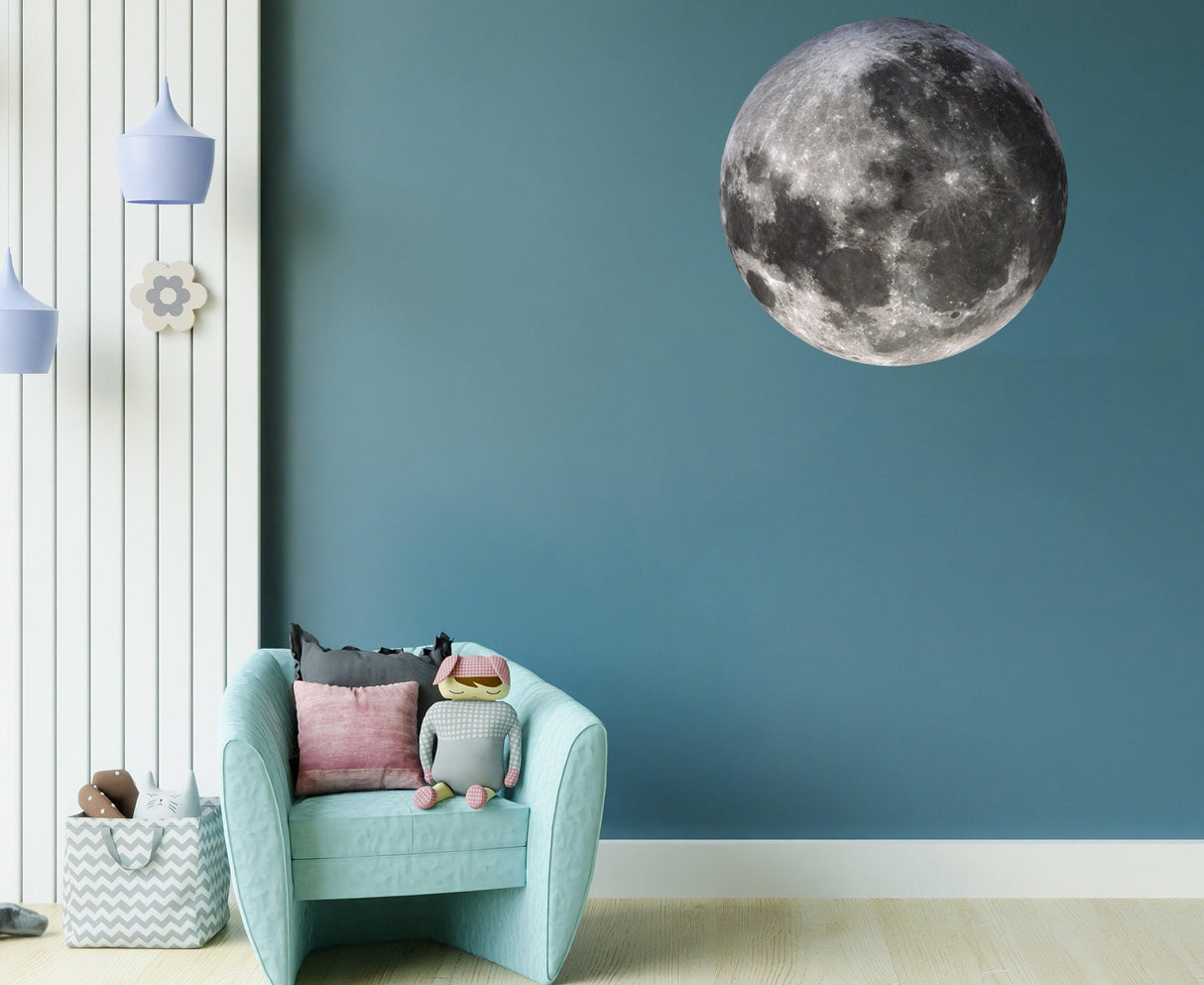 Full Moon Wall Sticker on blue wall above cozy chair, adding a whimsical touch to home decor.
