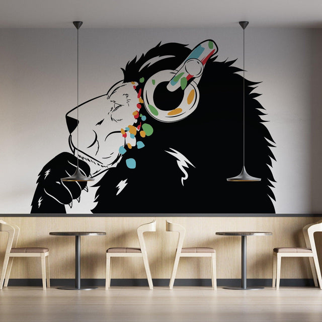 Lion wearing colorful headphones wall decal in modern cafe setting, inspired by Banksy graffiti style.