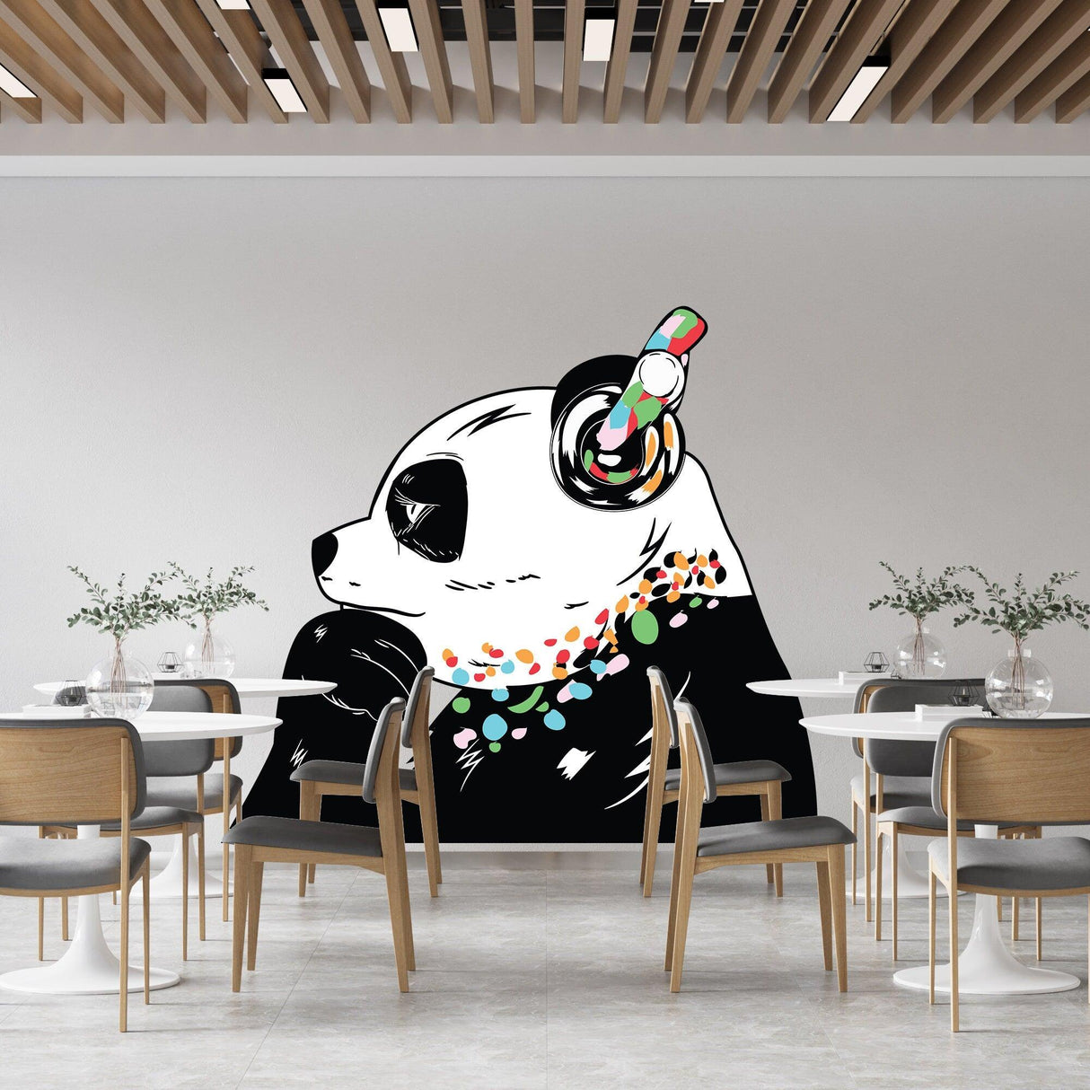Panda in headphones wall decal, inspired by Banksy, adds whimsy to modern dining space.
