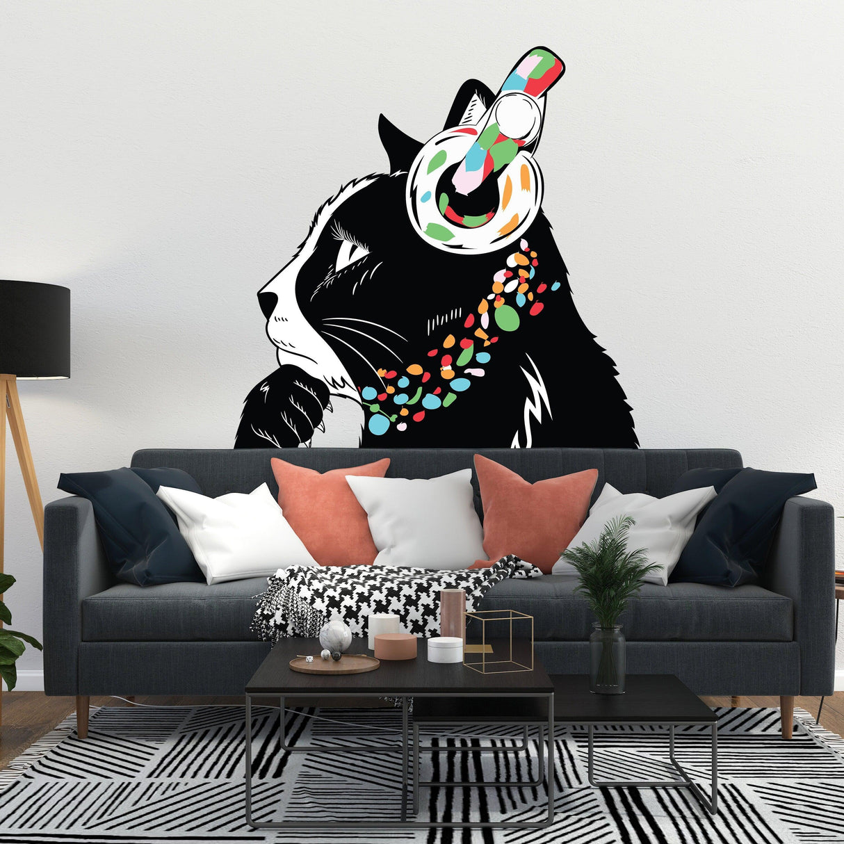 Thinking Cat Sticker with headphones on a wall above a stylish sofa, inspired by Banksy art.