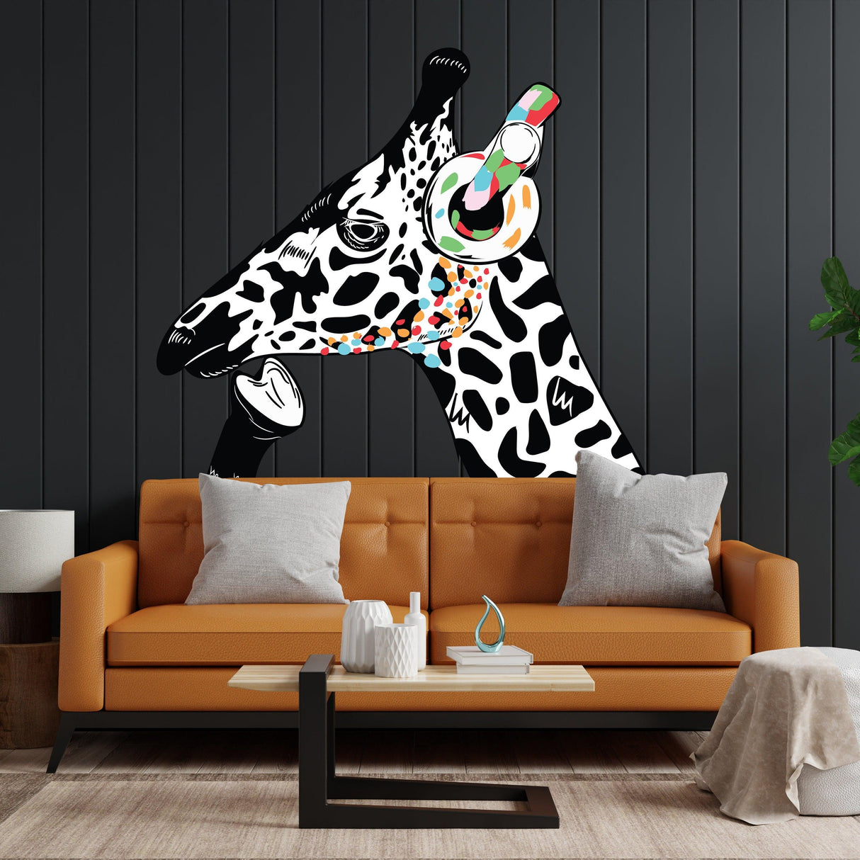 Giraffe in headphones wall sticker on dark wall above a modern orange sofa, inspired by Banksy graffiti style.