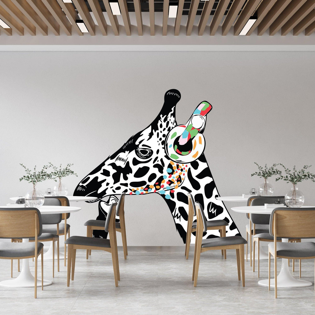 Giraffe wall art sticker featuring a playful giraffe wearing headphones in a modern dining room.