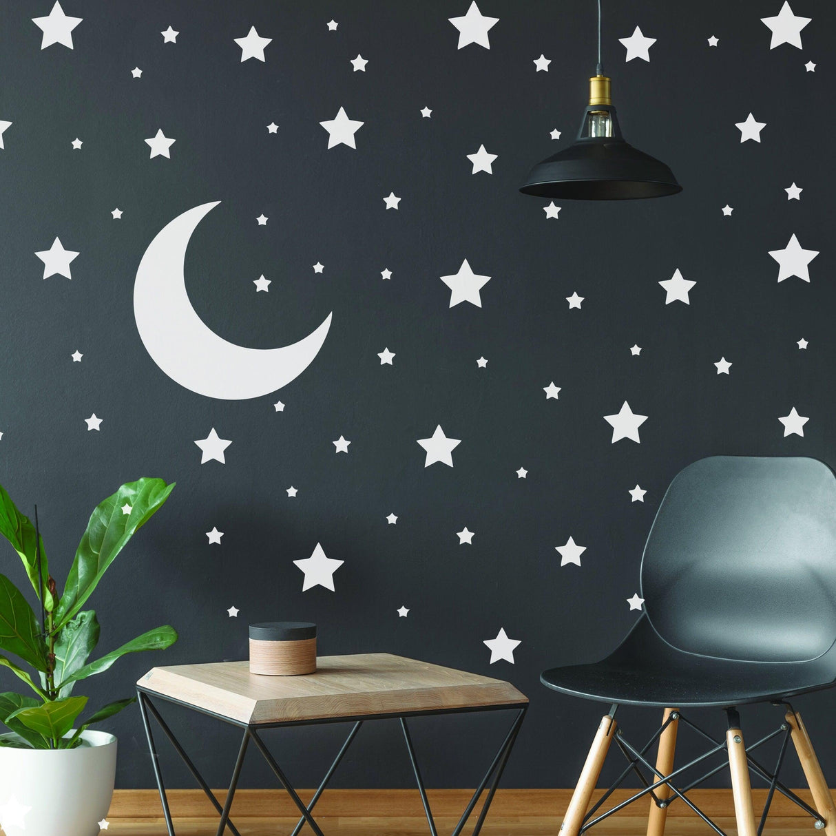 Stars and moon wall decals adorning a nursery's dark wall, adding a whimsical touch to the decor.