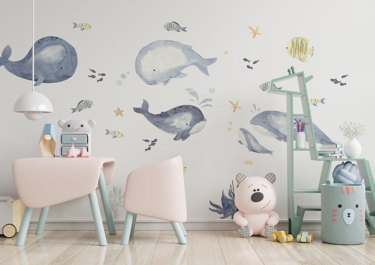 Ocean whales wall sticker in a kids room with cute decor, perfect for a baby boy nursery, featuring fish theme.