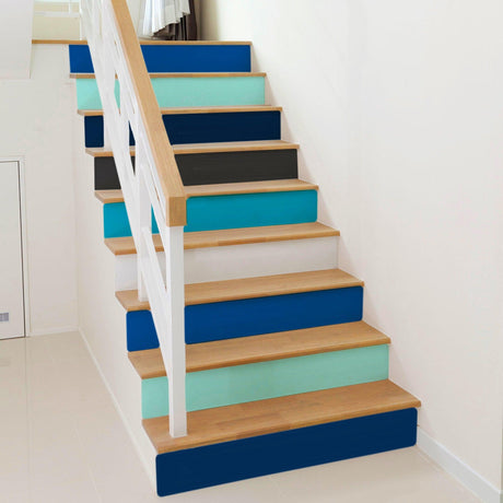 Gradient color self-adhesive stairs risers stickers on a wooden staircase, transforming its appearance with vibrant hues.