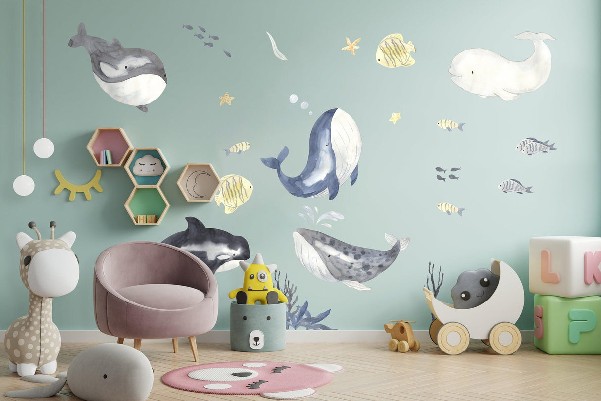 Ocean whales wall sticker for kids room decor with playful designs in an undersea theme.