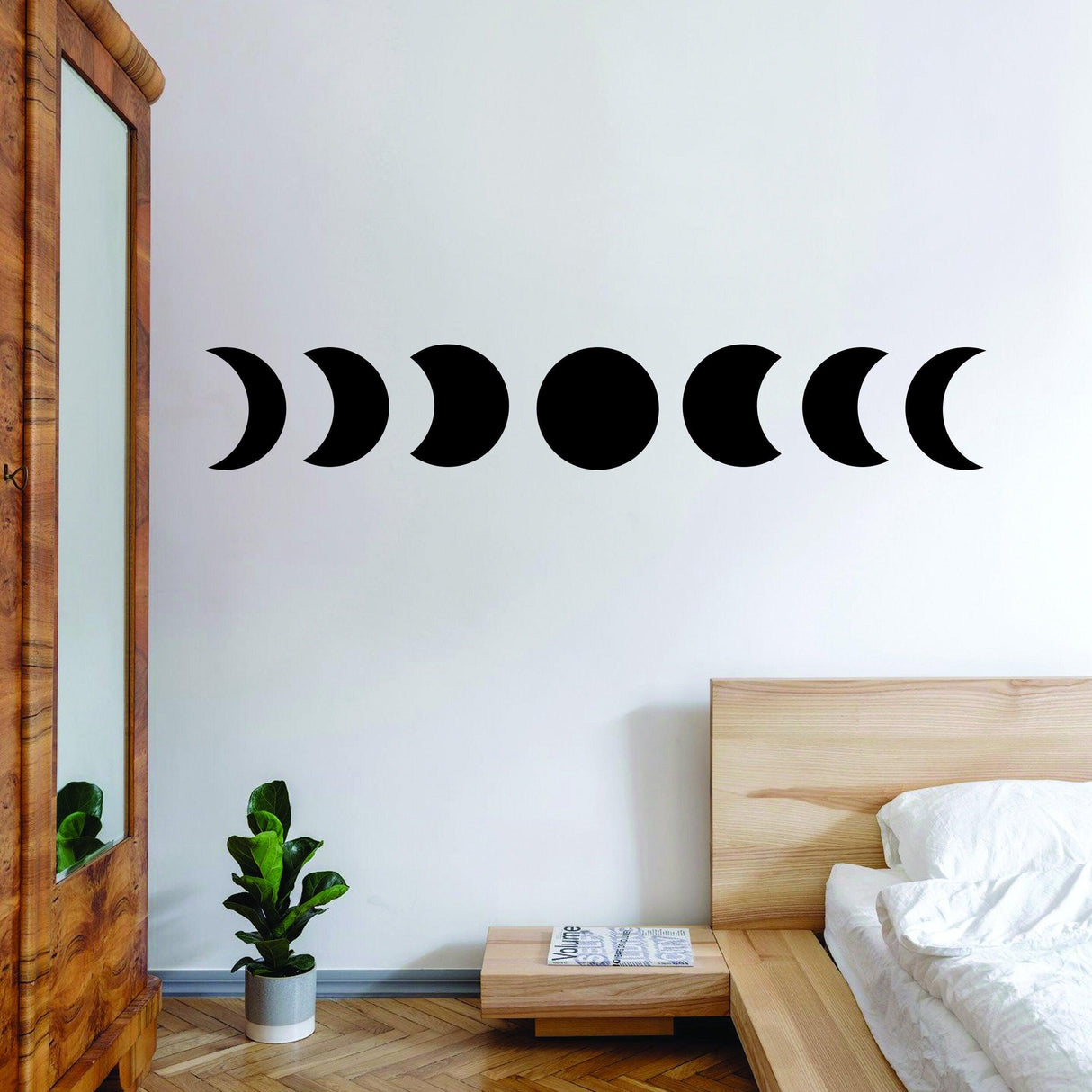 Moon Phase Wall Decor Sticker displaying lunar phases on a bedroom wall, adding celestial charm to the decor.