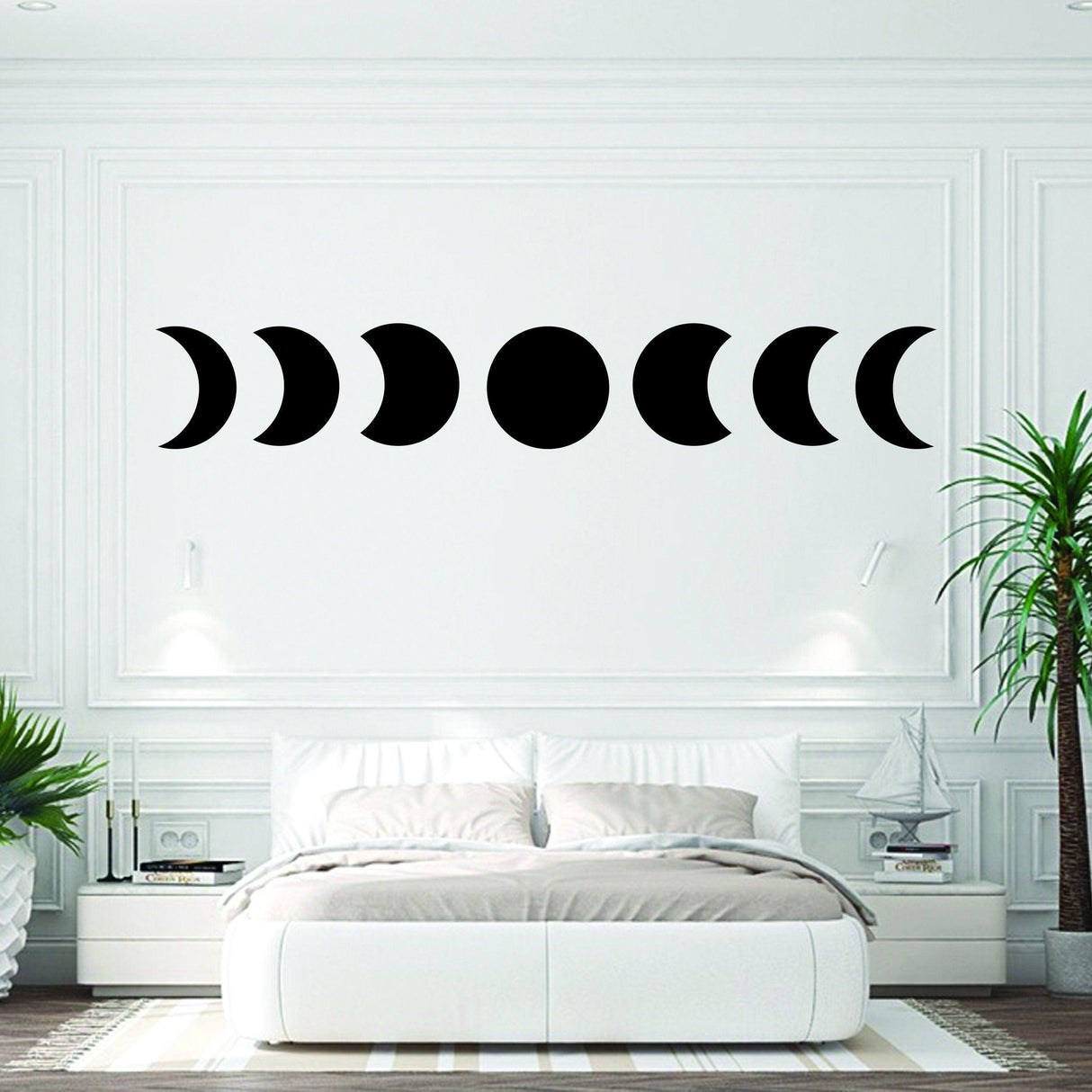 Moon phase wall decor sticker featuring intricate moon phases on white wall above a bed in a stylish room.