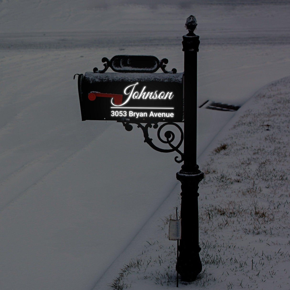 Personalized reflective mailbox decal displaying name 'Johnson' and address '3053 Bryan Avenue' in snowy landscape.